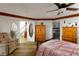 Cozy primary bedroom featuring a wood-trimmed ceiling, seating area, and adjacent bathroom for a relaxing retreat at 414 Crystal Canyon Dr, Mesquite, NV 89027