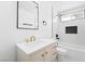 Modern bathroom with a white vanity, gold hardware, and a tiled shower with black fixtures at 4312 Chrysalis Dr, Las Vegas, NV 89121