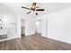 Bright bedroom features wood-look flooring, ceiling fan, closet and bathroom access at 4312 Chrysalis Dr, Las Vegas, NV 89121