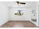 Bedroom with wood-look flooring, ceiling fan and window with palm trees at 4312 Chrysalis Dr, Las Vegas, NV 89121
