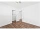 Clean bedroom with wood-look floors, neutral walls, and a closet with a sliding door at 4312 Chrysalis Dr, Las Vegas, NV 89121