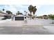 Charming single-story home with a well-manicured front yard, grey garage door, and white perimeter fence at 4312 Chrysalis Dr, Las Vegas, NV 89121