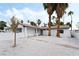 Charming single-story home featuring a white exterior, desert landscaping, and tall palm trees in the front yard at 4312 Chrysalis Dr, Las Vegas, NV 89121