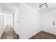 Bright hallway featuring wood-look floors and a white front door at 4312 Chrysalis Dr, Las Vegas, NV 89121