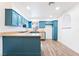 Well-lit kitchen featuring granite countertops, blue cabinets, modern appliances, and wood-look floors at 4312 Chrysalis Dr, Las Vegas, NV 89121