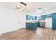 Modern kitchen featuring blue cabinets, stainless steel appliances, and wood floors at 4312 Chrysalis Dr, Las Vegas, NV 89121