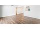 Spacious living room with wood-look floors and an archway to the dining room at 4312 Chrysalis Dr, Las Vegas, NV 89121