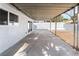 Covered patio featuring concrete flooring, metal support beams, and a white cinder block privacy wall at 4312 Chrysalis Dr, Las Vegas, NV 89121
