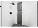 Modern shower with black fixtures and sleek, white tiling and black accents at 4312 Chrysalis Dr, Las Vegas, NV 89121