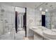 Luxurious bathroom featuring dual sinks, marble countertops and glass shower at 4381 W Flamingo Rd # 1121, Las Vegas, NV 89103