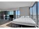 Modern bedroom featuring floor-to-ceiling windows with city views and sleek fireplace at 4381 W Flamingo Rd # 1121, Las Vegas, NV 89103