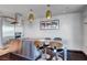 Contemporary kitchen island with seating, stainless steel appliances, dark wood floors, and modern lighting at 4381 W Flamingo Rd # 1121, Las Vegas, NV 89103