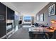 Living room with fireplace, TV, sofa, desk, and bed near large windows, offering a modern and comfortable space at 4381 W Flamingo Rd # 1121, Las Vegas, NV 89103