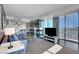 Contemporary living room with a comfortable sofa, fireplace, and open access to a modern kitchen and dining area at 4381 W Flamingo Rd # 1121, Las Vegas, NV 89103