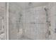 Walk-in glass shower featuring marble tile and dual shower heads at 4381 W Flamingo Rd # 1121, Las Vegas, NV 89103