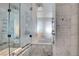 A beautifully designed bathroom with a glass shower and bathtub featuring marble tiling and sleek fixtures at 4381 W Flamingo Rd # 1206, Las Vegas, NV 89103