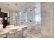 A stunning bathroom featuring double sinks, a glass-enclosed shower, and stylish marble tiling at 4381 W Flamingo Rd # 1206, Las Vegas, NV 89103