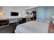 Well-lit modern bedroom area with dark floors and a workspace at 4381 W Flamingo Rd # 1206, Las Vegas, NV 89103