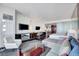 A spacious living area with modern decor including a sectional sofa and stylish entertainment center with multiple televisions at 4381 W Flamingo Rd # 1206, Las Vegas, NV 89103