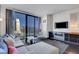 A contemporary living area with city views, a plush sofa, and modern entertainment setup at 4381 W Flamingo Rd # 1206, Las Vegas, NV 89103