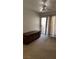 Bedroom with sliding glass door to outdoor balcony and ceiling fan with light at 4555 E Sahara Ave # 122, Las Vegas, NV 89104