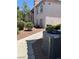 Condo exterior with neutral paint and maintained landscaping with HVAC unit visible at 4555 E Sahara Ave # 122, Las Vegas, NV 89104