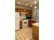 Kitchen with wood cabinets, white appliances, and a view of the sink and countertops at 4555 E Sahara Ave # 122, Las Vegas, NV 89104
