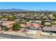 Aerial shot highlighting the home's curb appeal, neighborhood, and mountain views at 475 E Robindale Rd, Las Vegas, NV 89123