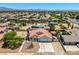 Expansive view of a single-story home with a two-car garage and desert landscaping in a residential community at 475 E Robindale Rd, Las Vegas, NV 89123