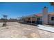 Large backyard with a covered patio and space for various outdoor activities at 475 E Robindale Rd, Las Vegas, NV 89123