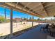 View from the covered patio looking out at the large backyard and block wall at 475 E Robindale Rd, Las Vegas, NV 89123