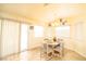 Cozy dining area with a round table, chairs, and sliding door at 475 E Robindale Rd, Las Vegas, NV 89123
