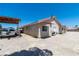 Single-story home featuring a tile roof and side parking with a carport at 475 E Robindale Rd, Las Vegas, NV 89123