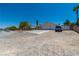 This property features a spacious driveway, desert landscaping, and an attached two-car garage on a quiet street at 475 E Robindale Rd, Las Vegas, NV 89123
