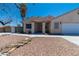 Charming home with desert landscaping featuring a decorative rock garden and a covered front entrance at 475 E Robindale Rd, Las Vegas, NV 89123