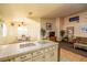Spacious kitchen with tile counters and bar seating blending into a dining and living area at 475 E Robindale Rd, Las Vegas, NV 89123