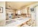 Functional kitchen featuring tile countertops, modern appliances, and bar seating at 475 E Robindale Rd, Las Vegas, NV 89123
