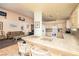 Open kitchen with a breakfast bar overlooking a living area with modern appliances at 475 E Robindale Rd, Las Vegas, NV 89123