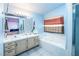 Bathroom featuring double sinks, a tub, and a separate glass enclosed shower at 475 E Robindale Rd, Las Vegas, NV 89123