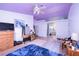 Spacious bedroom featuring a ceiling fan and personal refrigerator at 475 E Robindale Rd, Las Vegas, NV 89123