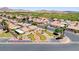 Aerial view of a residential area showcasing putting greens, landscaped properties, and well-maintained homes at 5043 Mascaro Dr, Las Vegas, NV 89122