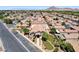 An aerial view showcases a community clubhouse with putting greens, a pool, parking, and charming single-story homes at 5043 Mascaro Dr, Las Vegas, NV 89122