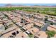 An aerial view of a desert community of houses featuring solar panels and covered patios at 5043 Mascaro Dr, Las Vegas, NV 89122