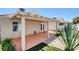 Inviting covered patio features low-maintenance landscaping, exterior access doors, and hardscape accents at 5043 Mascaro Dr, Las Vegas, NV 89122