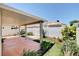 Relaxing covered patio with lush plantings, stone pathway, and privacy fencing at 5043 Mascaro Dr, Las Vegas, NV 89122