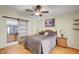 Bedroom view features wood floors, ceiling fan and sliding barn door to the bathroom at 5043 Mascaro Dr, Las Vegas, NV 89122