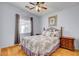 Bedroom view features natural light, ceiling fan, wood floors and a decorative bed frame at 5043 Mascaro Dr, Las Vegas, NV 89122