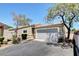 Charming single-story home with a two-car garage, desert landscaping, and a well-maintained front yard at 5043 Mascaro Dr, Las Vegas, NV 89122
