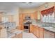 Stylish kitchen with granite countertops, stainless appliances, and natural wood cabinets at 5043 Mascaro Dr, Las Vegas, NV 89122