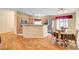 Bright kitchen featuring wood cabinetry, granite countertops, and a cozy dining area at 5043 Mascaro Dr, Las Vegas, NV 89122